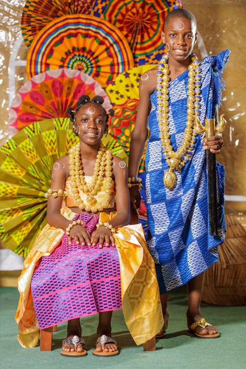 Children in Traditional Colorful Gowns and Jewelry 