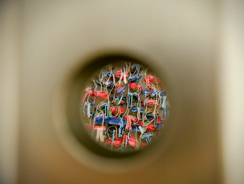 Colorful Items seen through a Round Hole in a Surface 