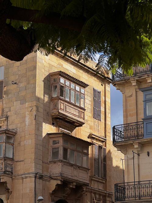 Free Charming historic buildings with traditional Maltese wooden balconies in Valletta, showcasing unique architectural style. Stock Photo