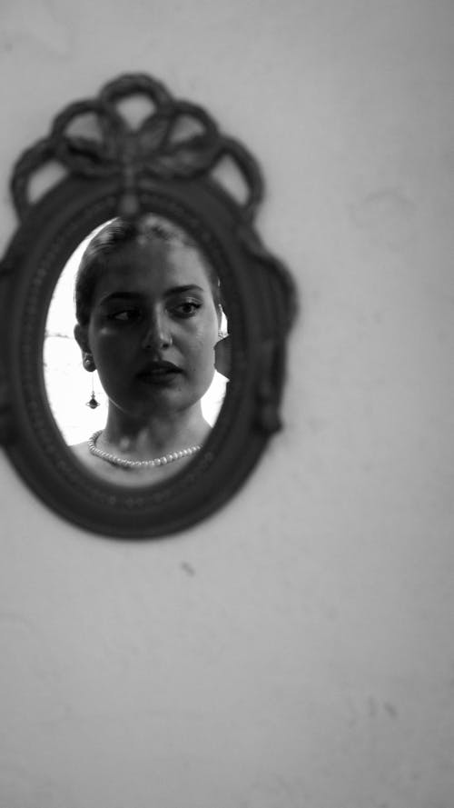 Reflection of a Woman in a Mirror