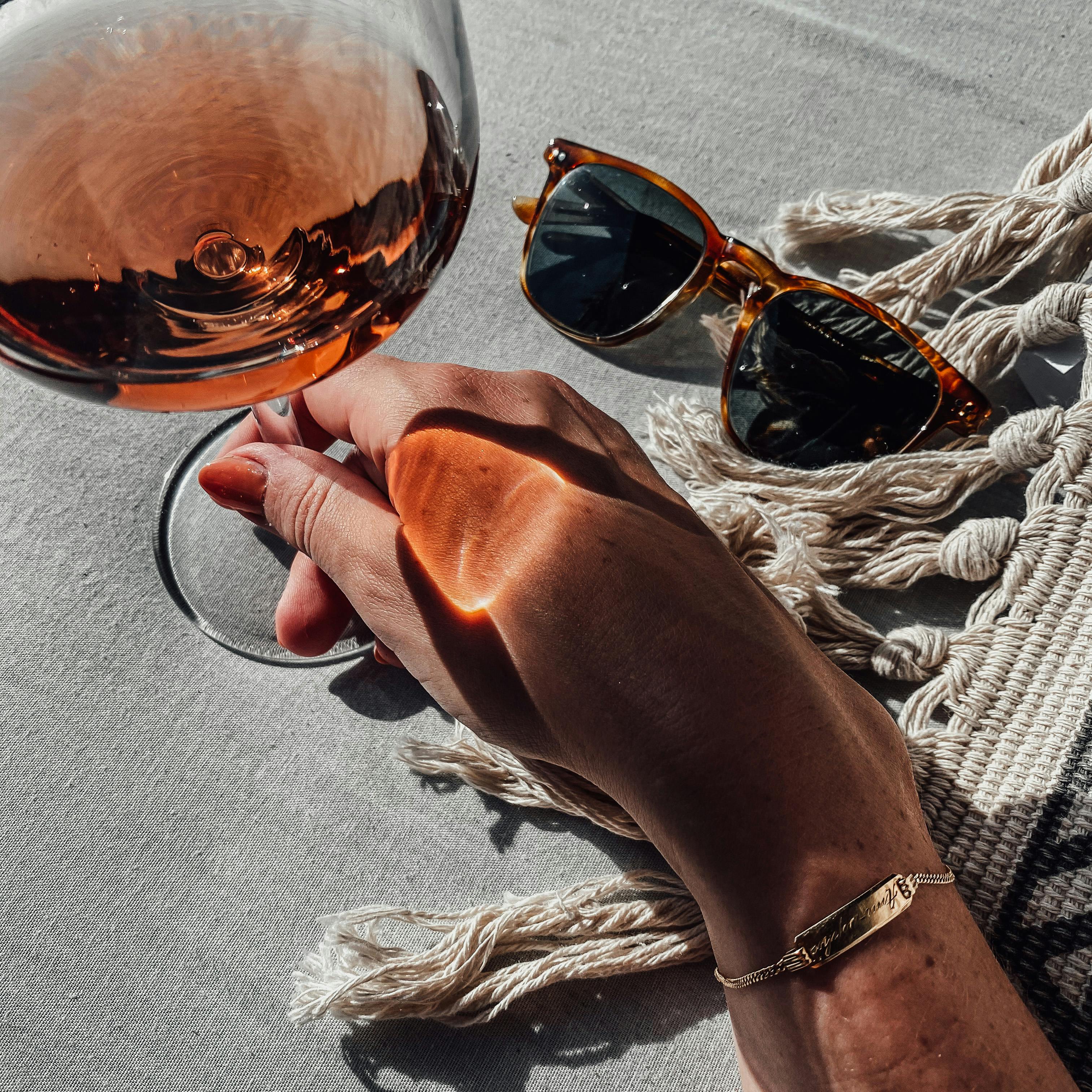 https://images.pexels.com/photos/16176317/pexels-photo-16176317/free-photo-of-woman-holding-a-glass-of-red-wine.jpeg