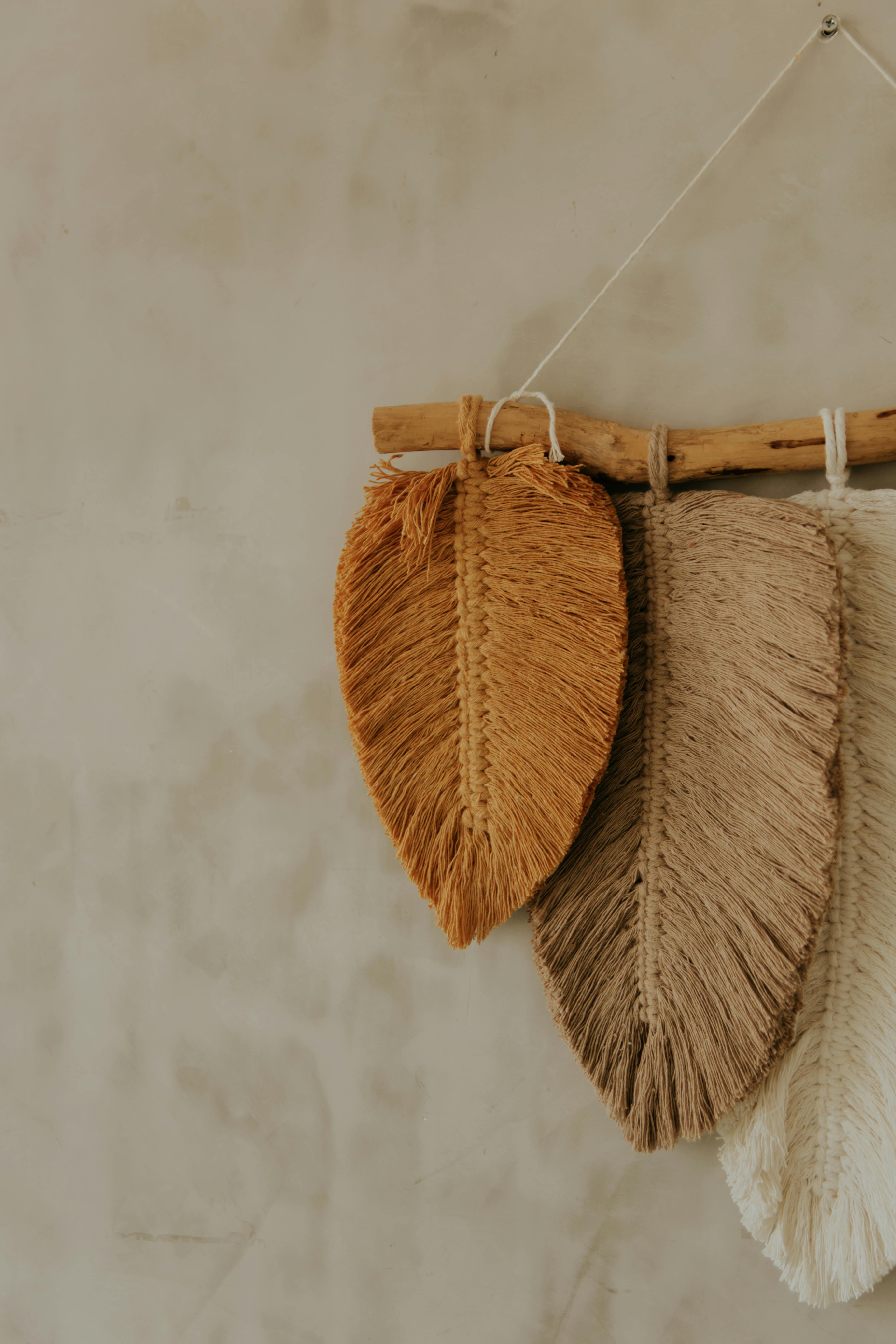 Free A minimalist wall hanging decor made with natural fibers in earthy tones, perfect for home decoration. Stock Photo