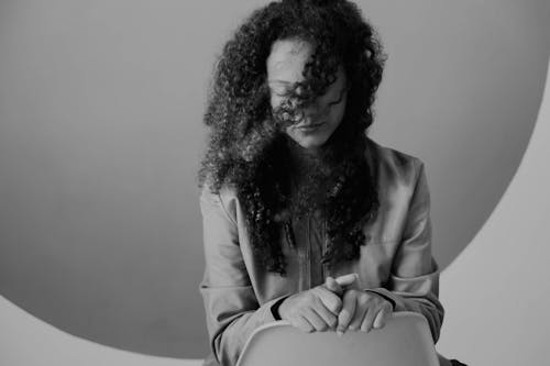 Woman with Curly Hair Posing with Eyes Closed