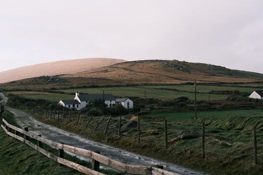 Tranquil rural landscape in Killarney, Ireland featuring farmhouses and rolling hills.