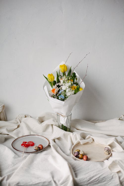 Still Life with a Wrapped Bouquet on a Table, Fruits on Plates, and White Drape