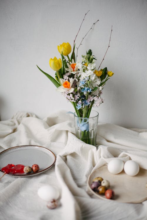 A Bunch of Flowers in a Vase and Plates with Eggs 