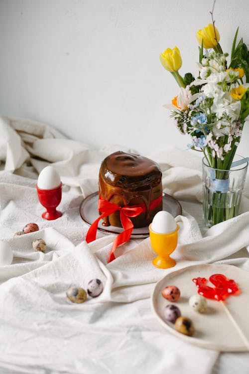 Easter Decoration with Flowers and Eggs on a Draped Tablecloth