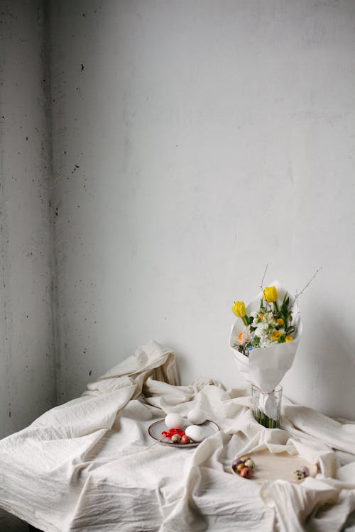 Still Life with Easter Eggs and a Bouquet on a Draped Tablecloth