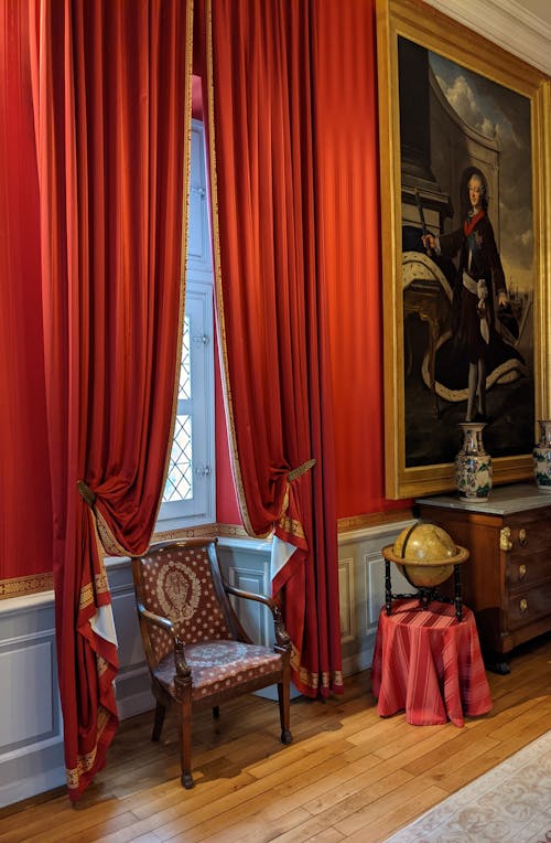 Red Curtains near Painting in Museum