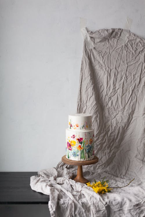 Still Life with a Floral Decorative Cake on a Gray Drape