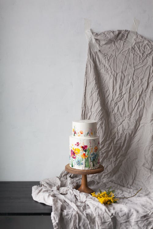 Free Still Life with a Floral Decorative Cake on a Gray Drape Stock Photo