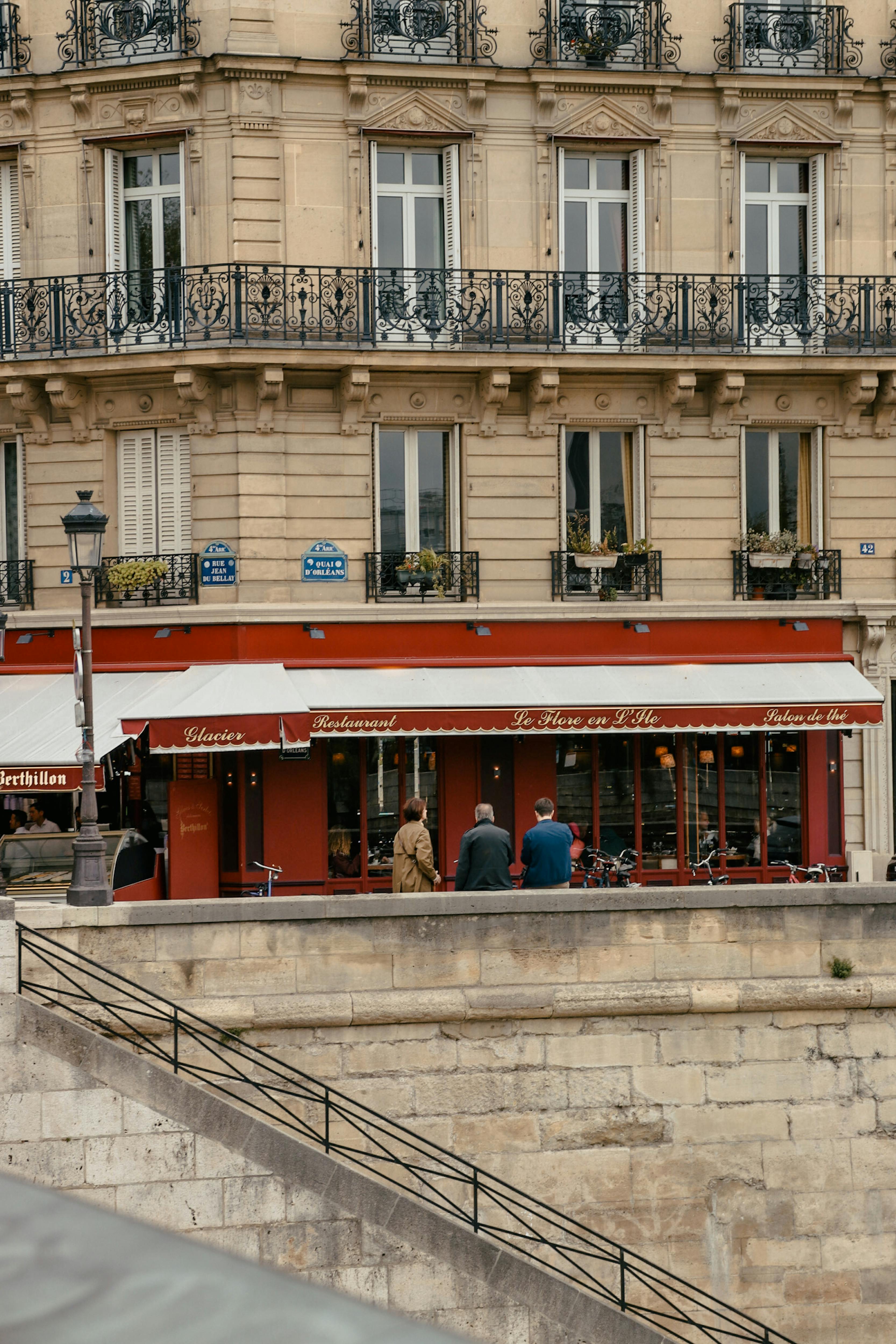 A classic Paris street view featuring a cozy cafe with elegant architecture.