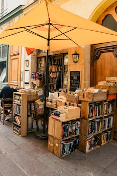 Quaint outdoor bookshop in Paris with vintage shelves and vibrant umbrella.