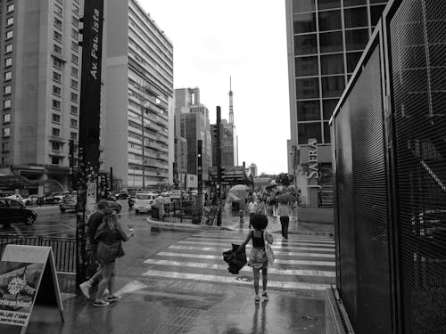People Walking in City after Rain