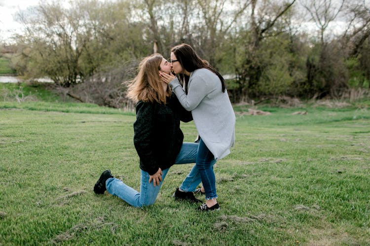 Man Proposing To A Woman And Kissing Her