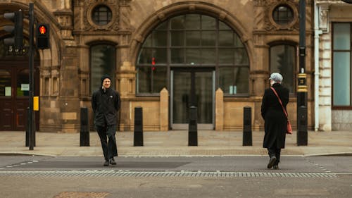 Woman and Man Crossing on Red Light