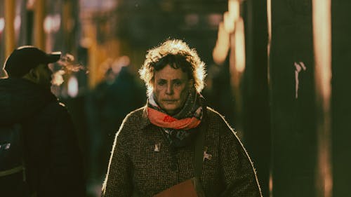 Portrait of a Senior Woman Standing on the Street at Night