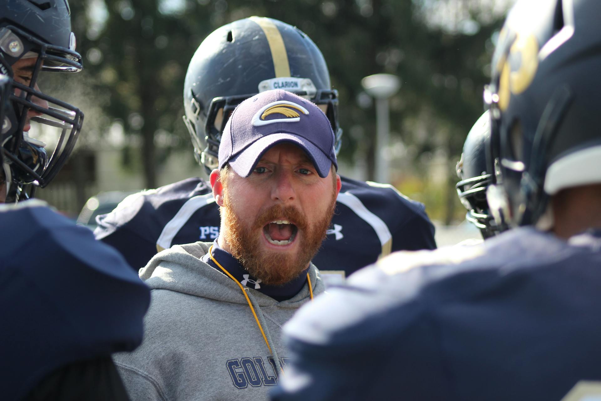 Man in Blue and White Jacket Wearing Black Helmet
