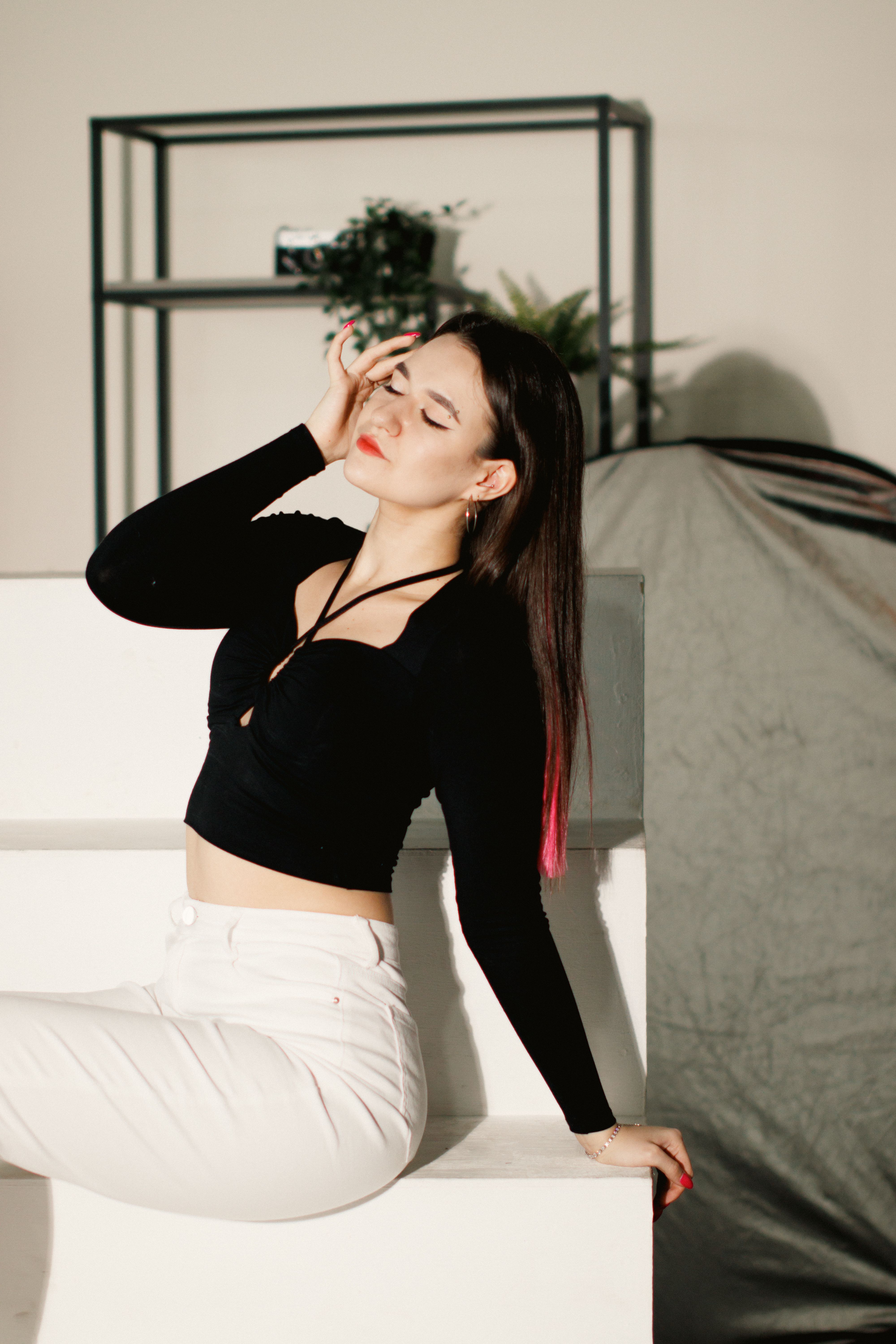 Portrait of a Woman Sitting with her Eyes Closed · Free Stock Photo