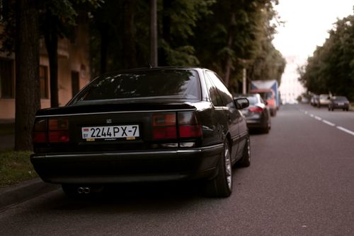 Free A serene urban street scene with parked cars at dusk, showcasing city life. Stock Photo