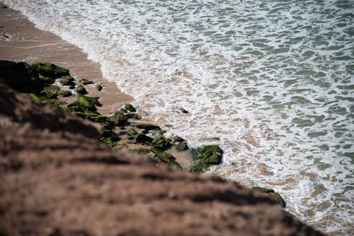 Free A serene view of ocean waves crashing against a rocky shoreline, showcasing the beauty of nature. Stock Photo