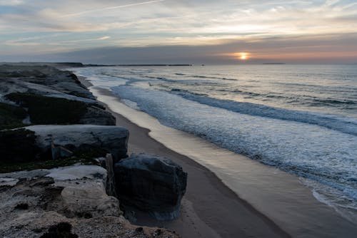 View of Cliffs, Beach and Sea at Sunset