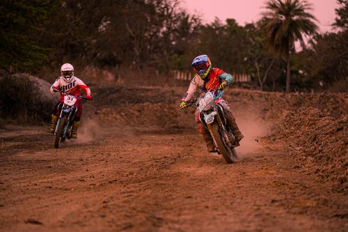 Free Exciting motocross race showcasing skilled riders on a dirt track surrounded by nature. Stock Photo