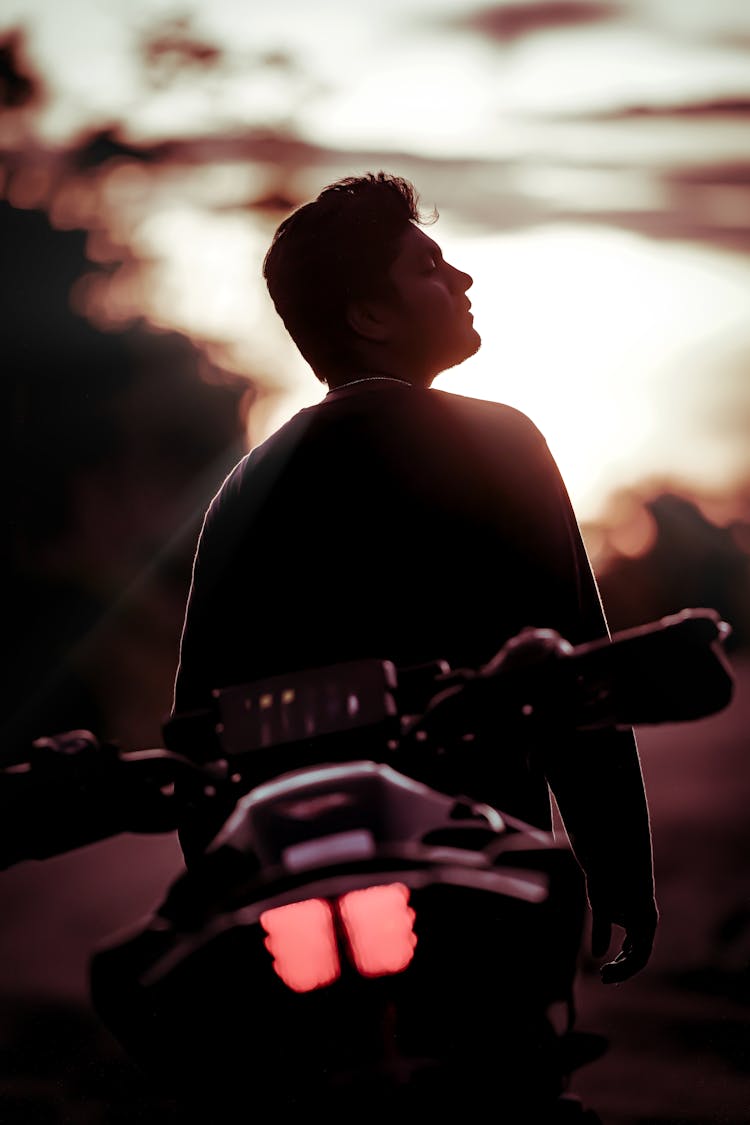 Silhouette Of Man With Motorcycle