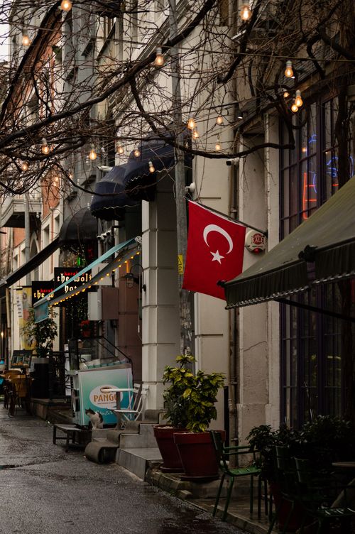 Free Cozy Istanbul street with Turkish flag and cafes, under winter lights. Stock Photo