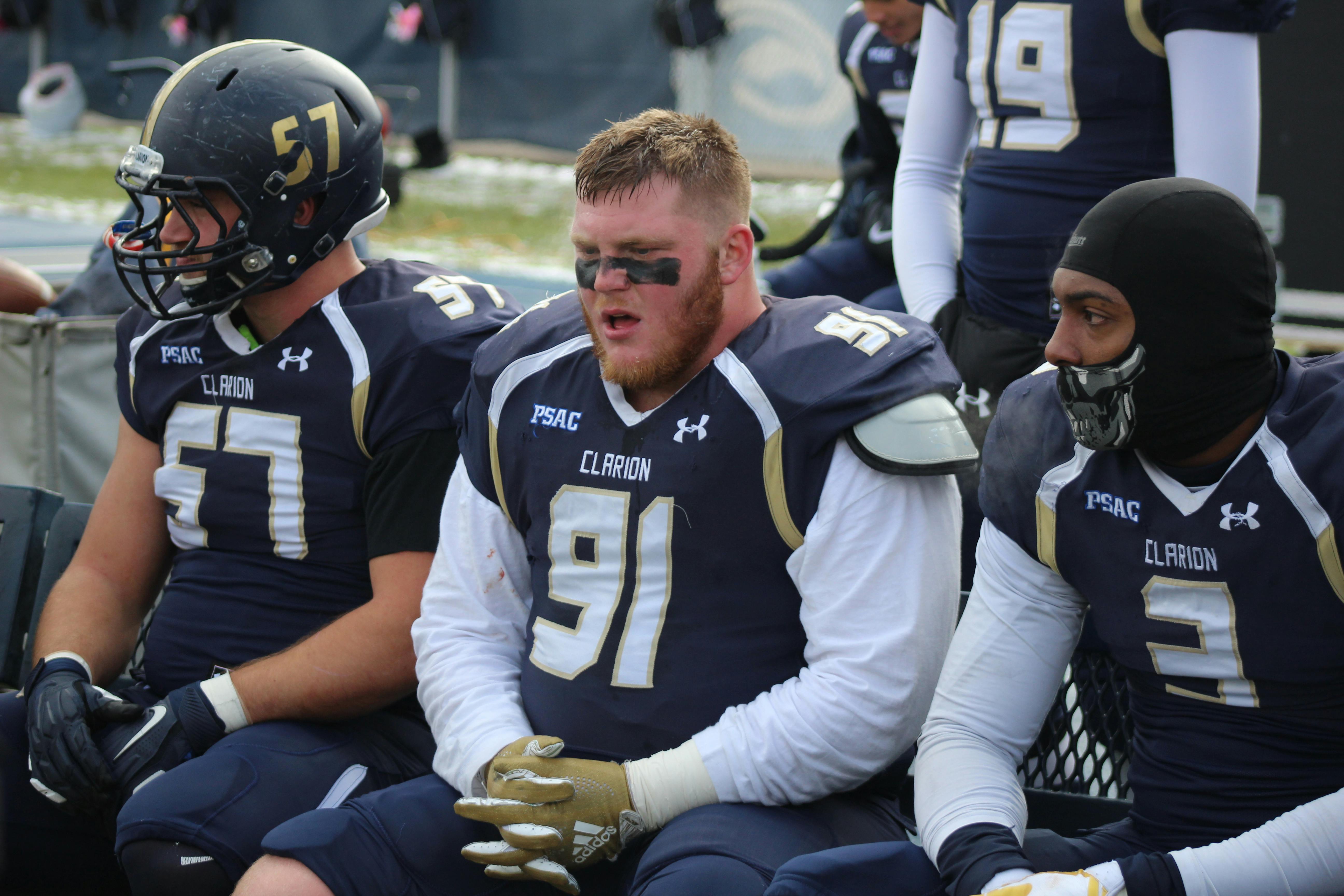 Football players in action with crowd in the stadium