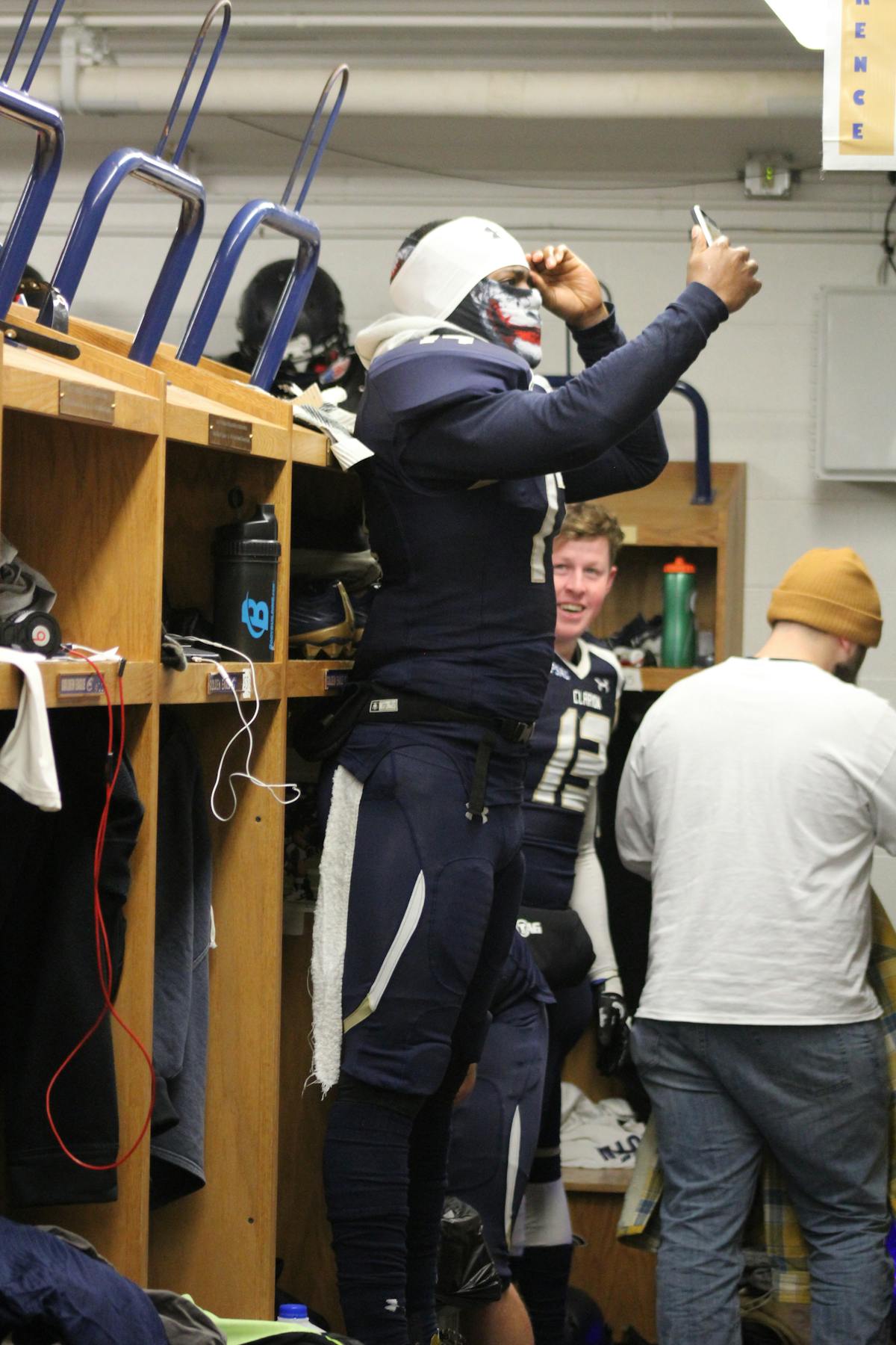 Wide receiver leaping to make a catch over a defender