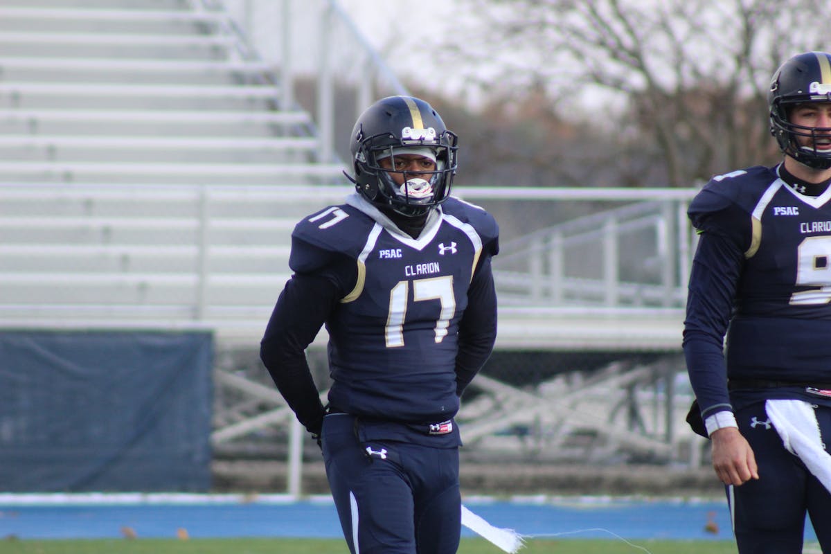 Football quarterback scrambling outside the pocket while looking downfield