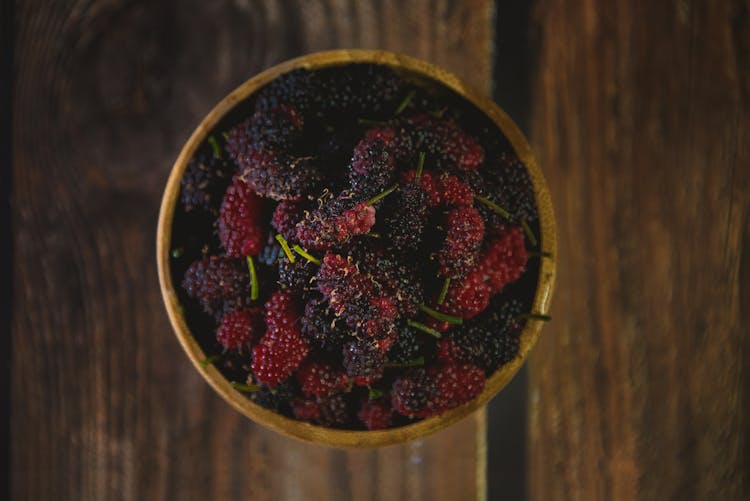 Close-up Of A Bowl With Berries Standing On A Wooden Surface 