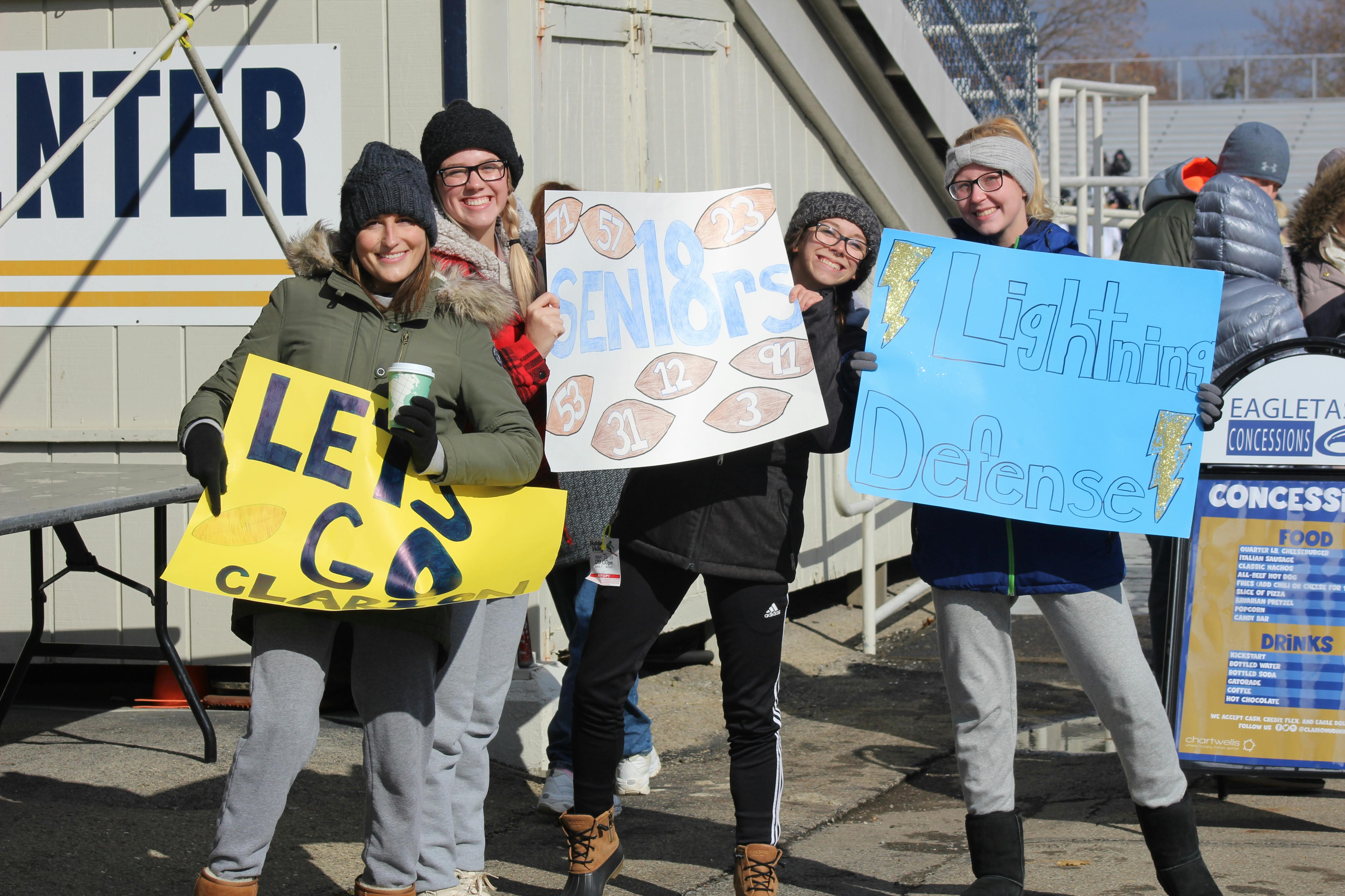 Football players huddling together in a team circle
