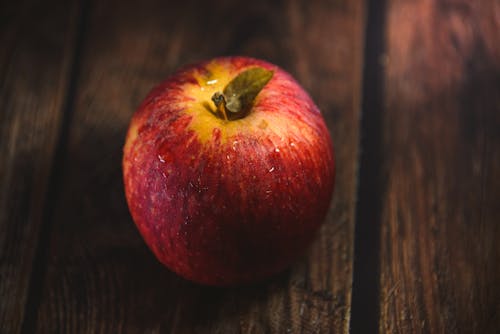 Close-up of a Red Apple Lying on a Wooden Surface