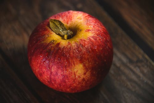 Close-up of a Red Apple Lying on a Wooden Surface