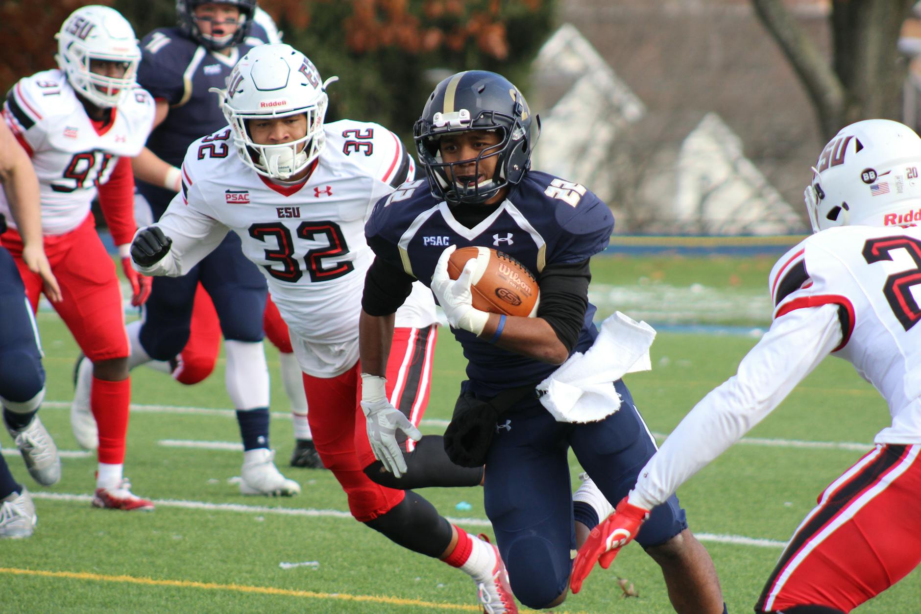 Football Player Carrying Brown Football