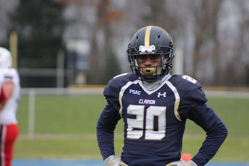 Football Player Standing on Field