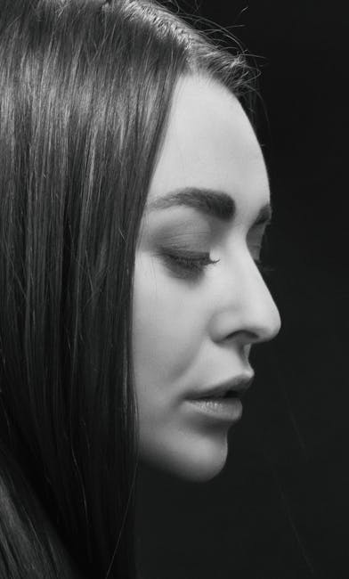 Captivating black and white portrait of a brunette woman in profile view.