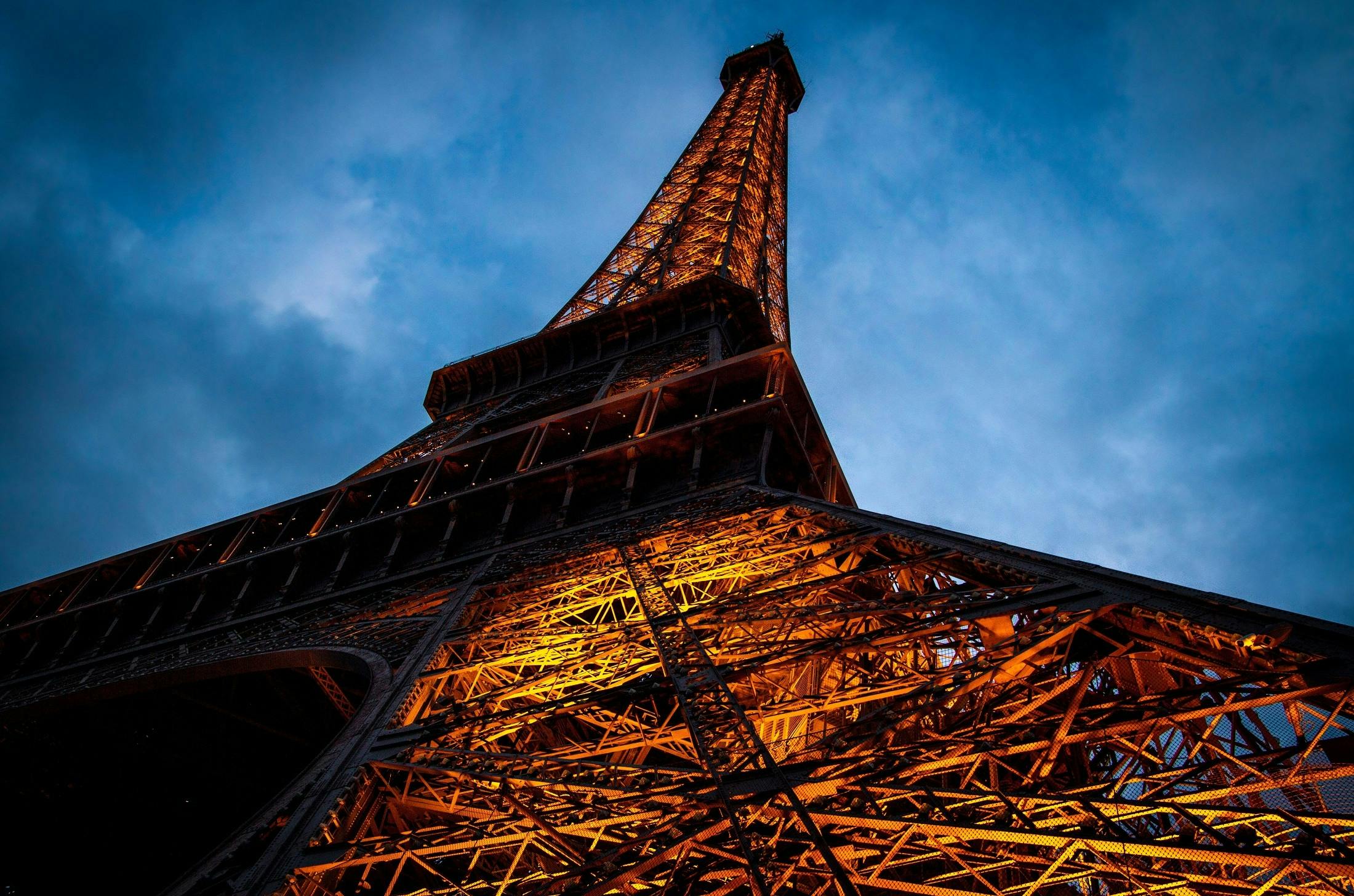 Eiffel Tower Under Cloudy Sky during Nighttime