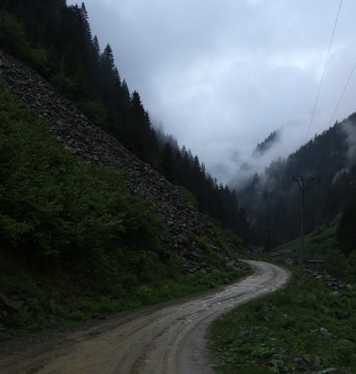 Dirty Road in Mountains on Gloomy Day
