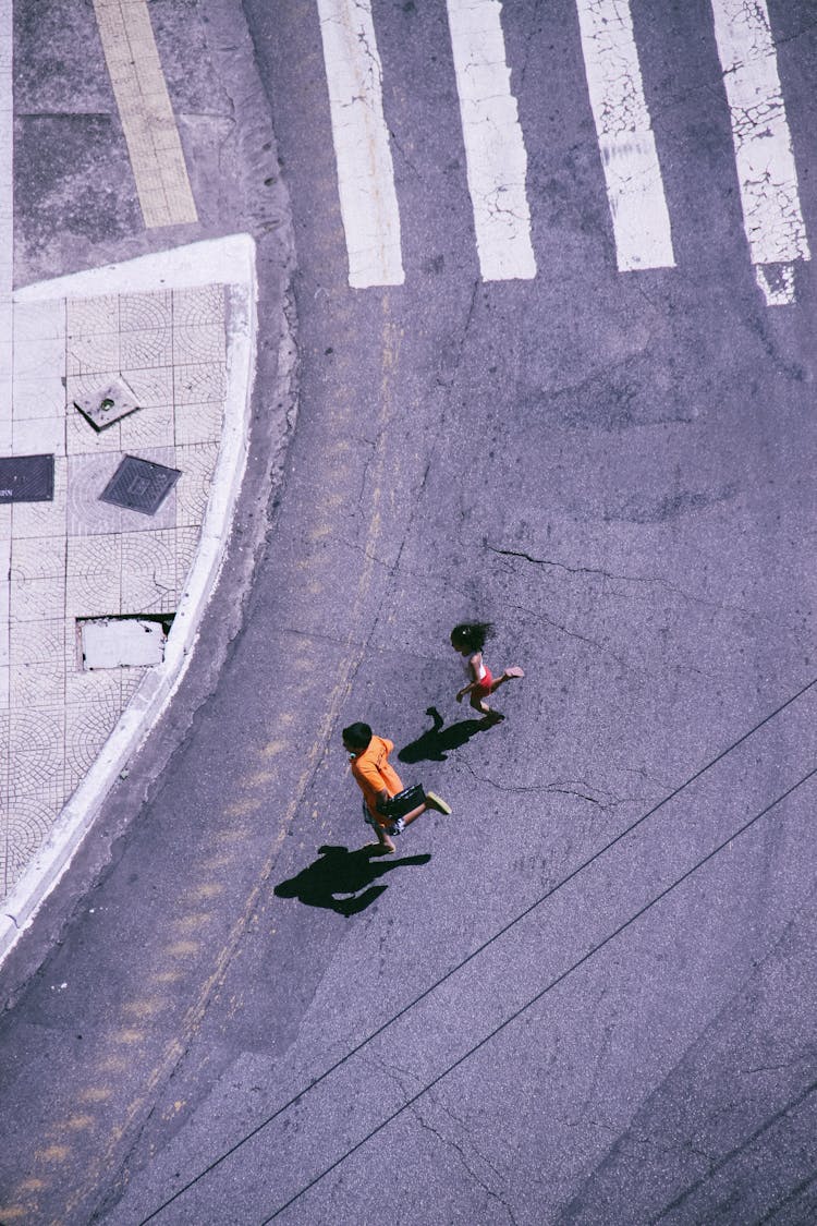 Children Running On Road Crossing