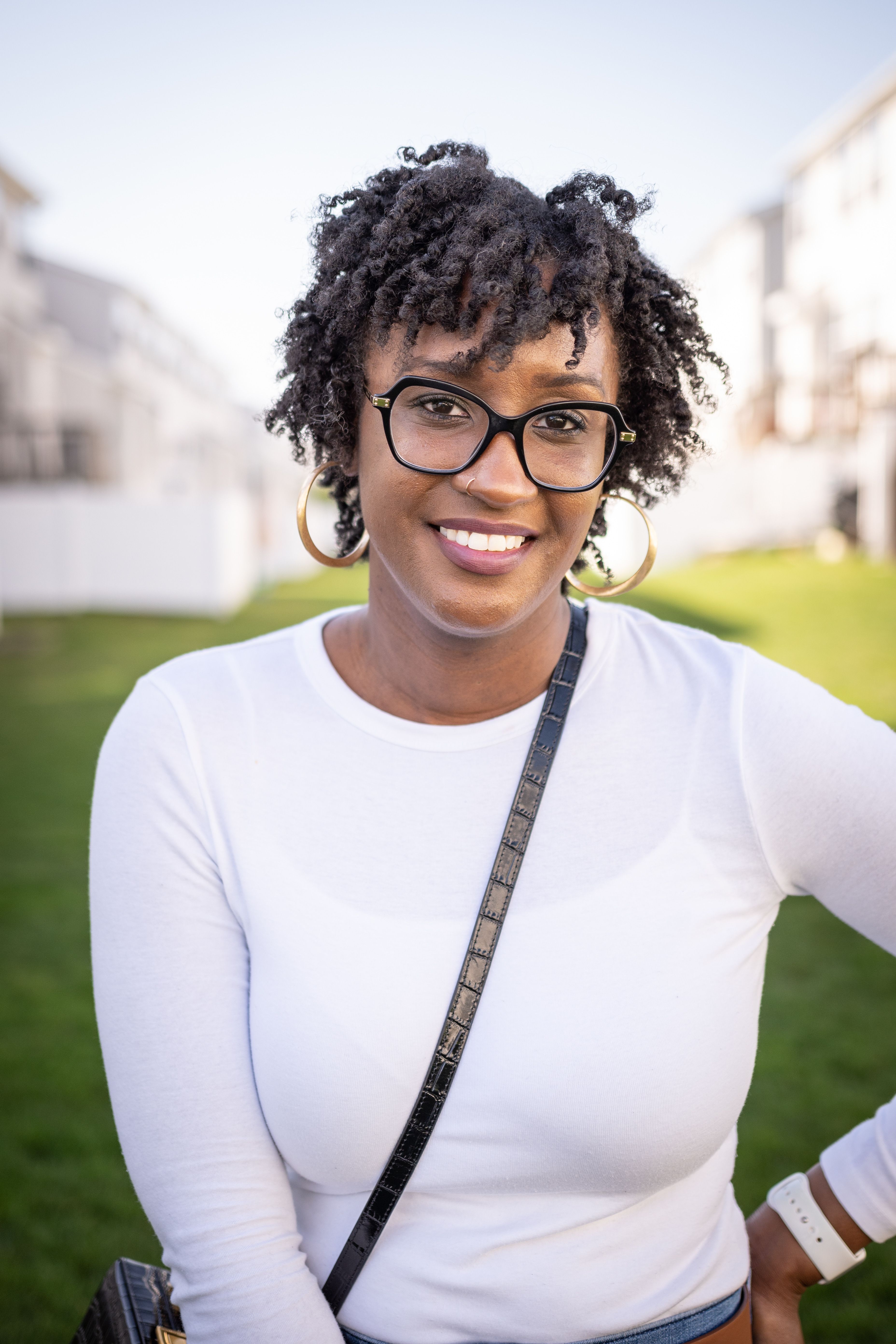 Portrait of a Young Woman with Curly Hair Smiling at the Camera · Free ...