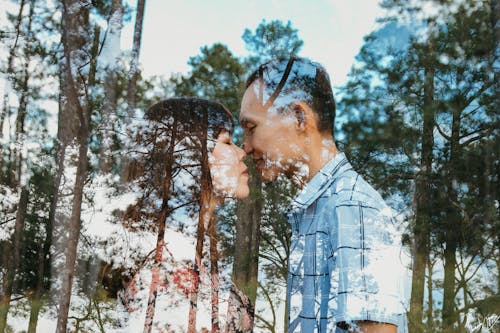 Reflection of a Couple Kissing, and Trees behind the Glass