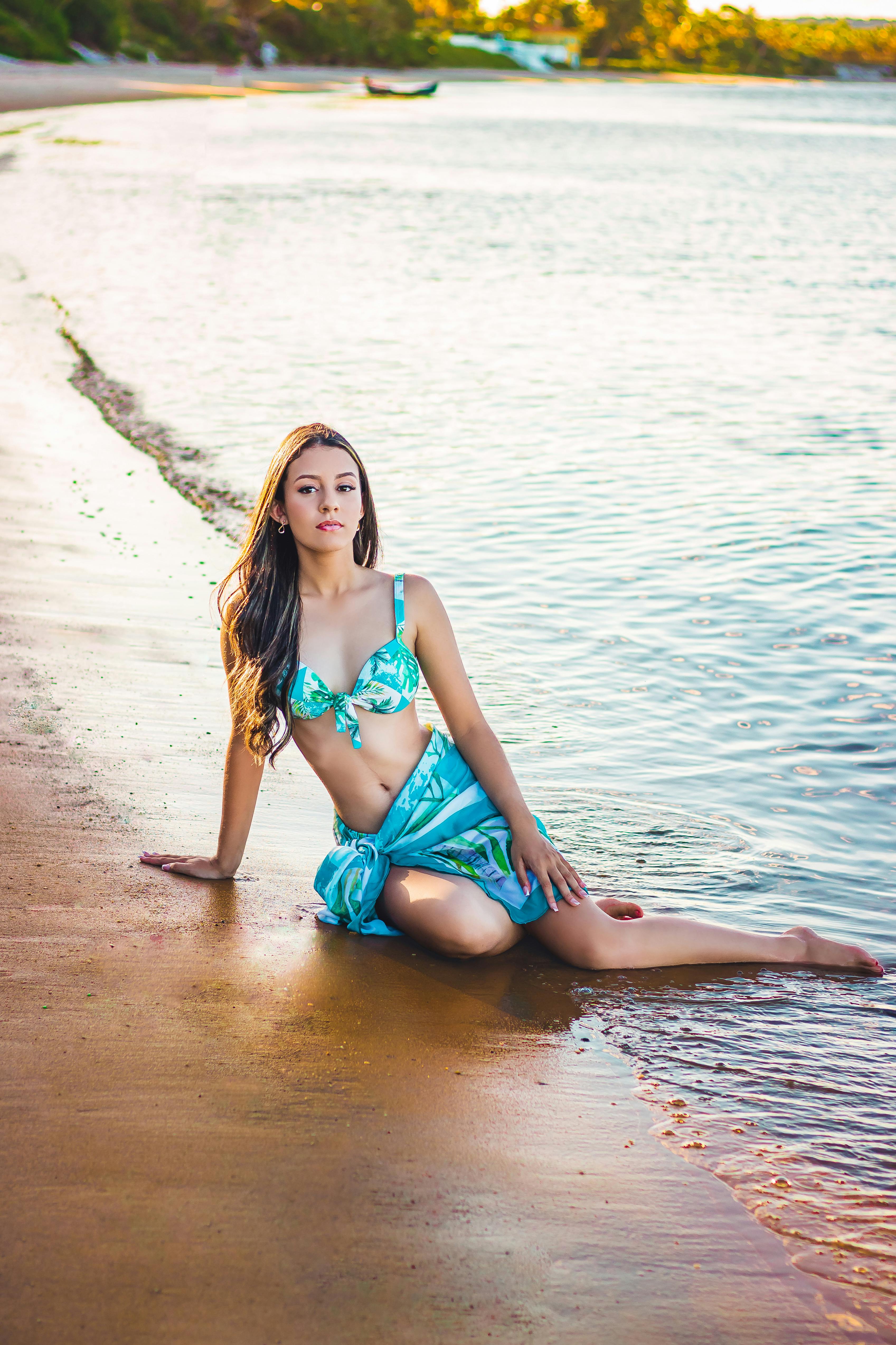 Woman in Yellow Bikini Top Lying on Beach Shore · Free Stock Photo