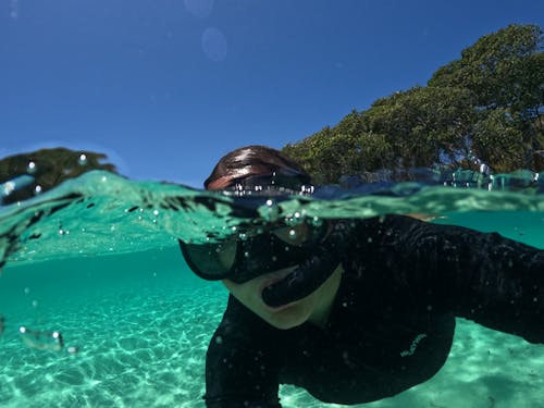 Person Snorkeling near the Coast