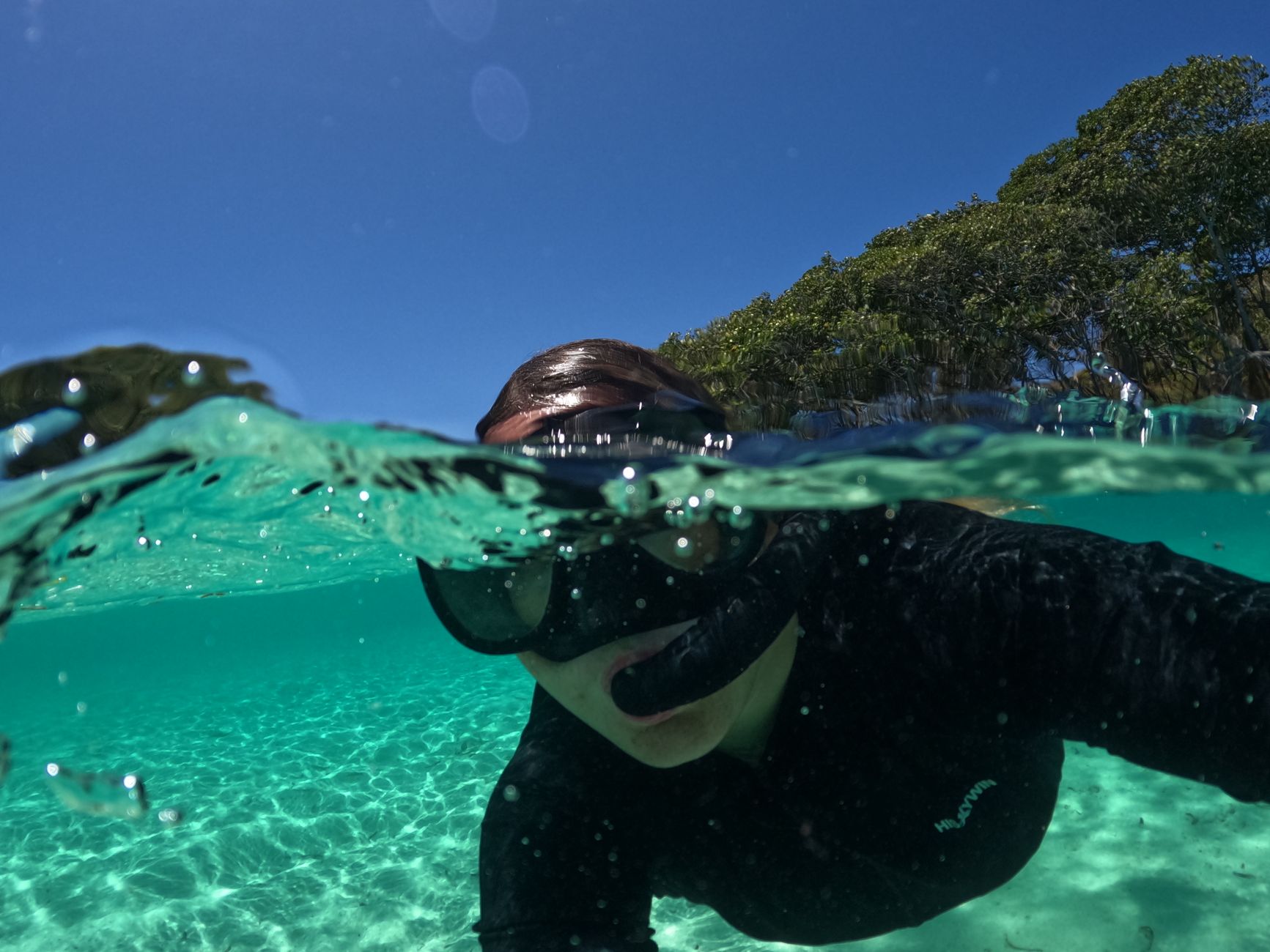 A snorkeller in clear coastal water, the sort of wearer who needs an SPF that is both protective and genuinely wearable