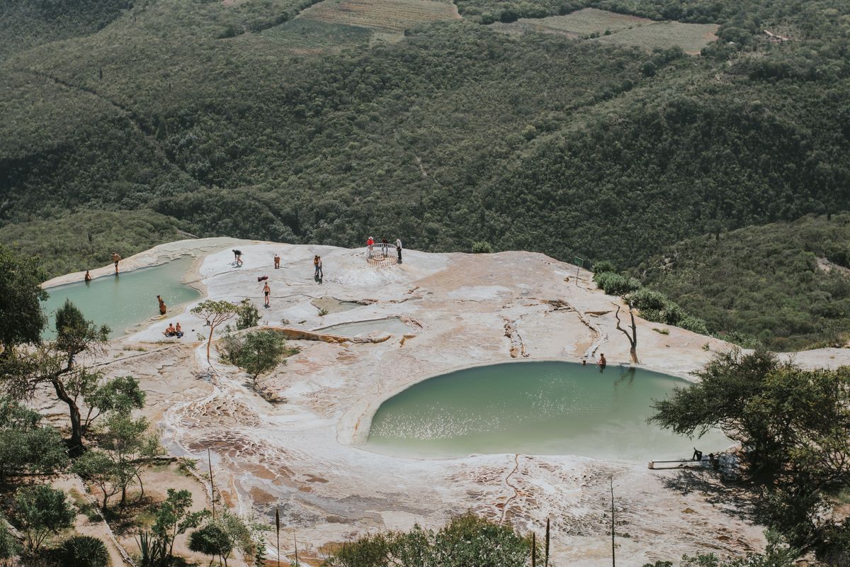 Tourists enjoy the natural rock formations and mineral pools of Hierve el Agua in Oaxaca.