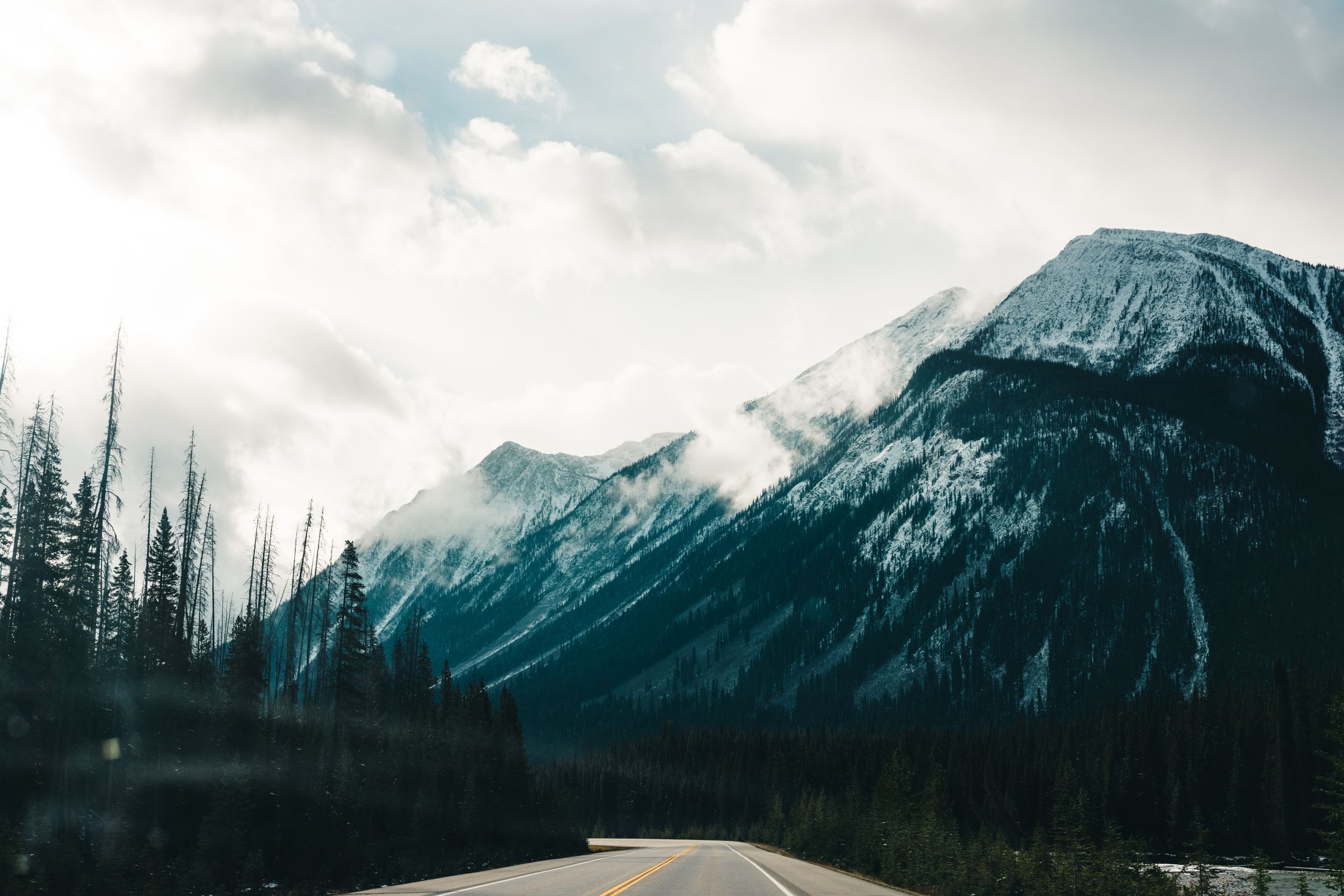 Breathtaking view of the snow-capped mountains and road in Banff National Park, Alberta, Canada.