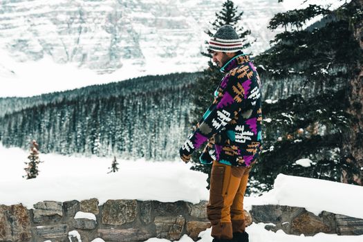 Man exploring snowy landscape in Banff National Park during winter.